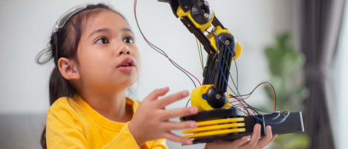 Girl holding a robot arm assembly