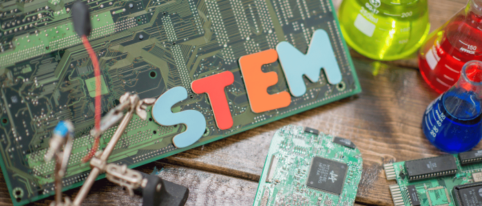 Circuit boards and soldering equipment with the letters STEM laid on top