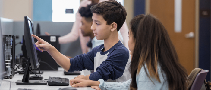 Boy and girl working together at a computer