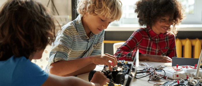 Boys working on a robot car