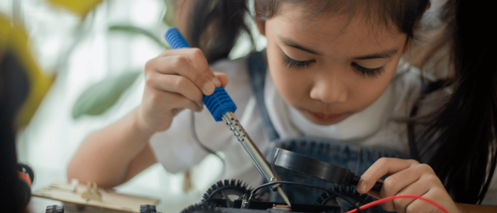Girl working on a robot car